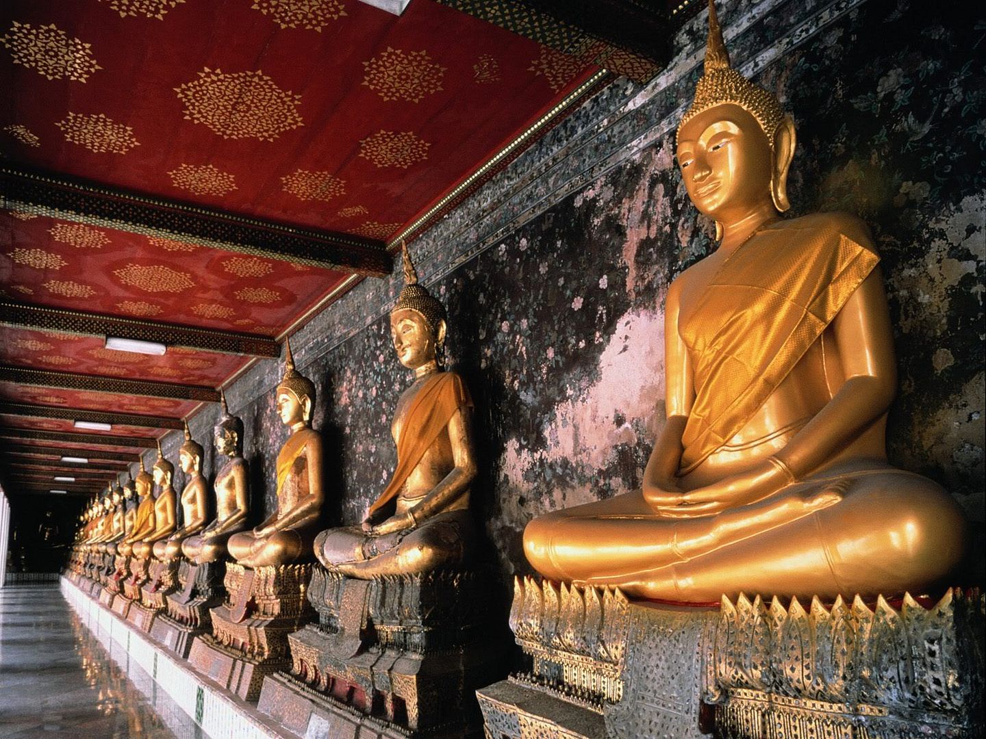 RowofGoldenBuddhasBangkokThailand.jpg